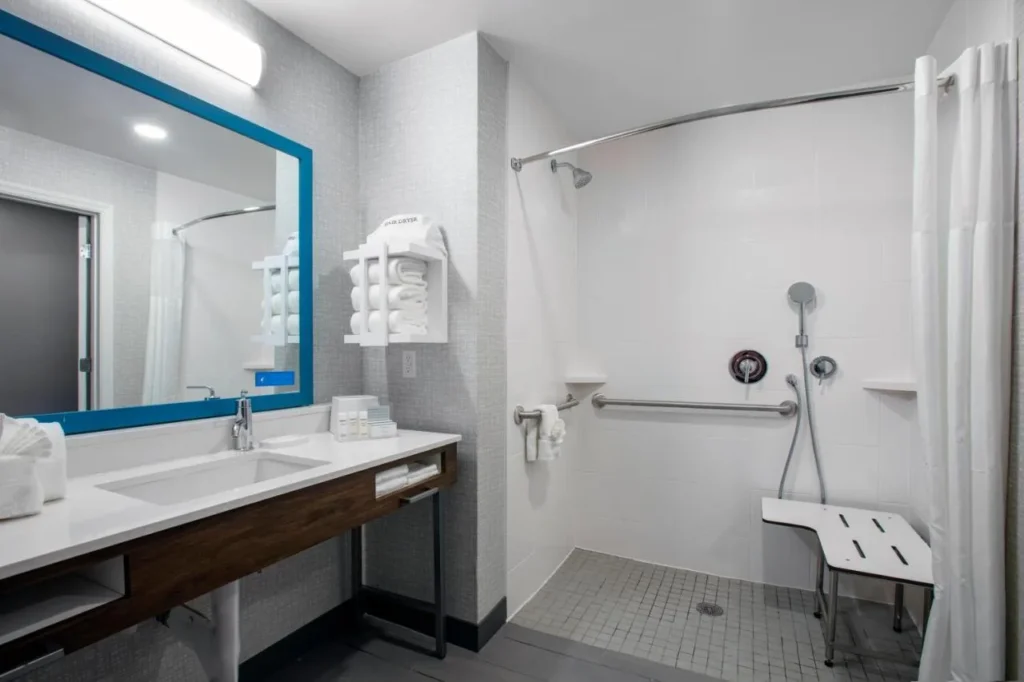 Accessible bathroom with roll-in shower, grab bars and shower bench at Hampton Inn Orlando/Lake Buena Vista