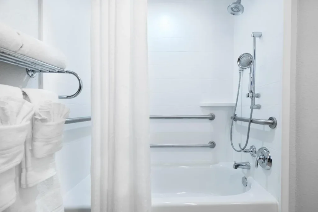 Accessible bathtub with grab bars and handheld shower at Holiday Inn Express Nearest Universal Orlando