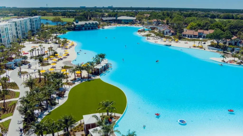 Aerial view of Evermore Bay lagoon, its sand beaches and the Flats at Evermore Orlando Resort