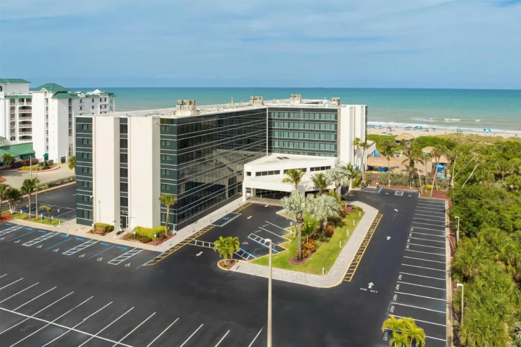 Aerial view of Hilton Cocoa Beach Oceanfront beside the beach and Atlantic Ocean