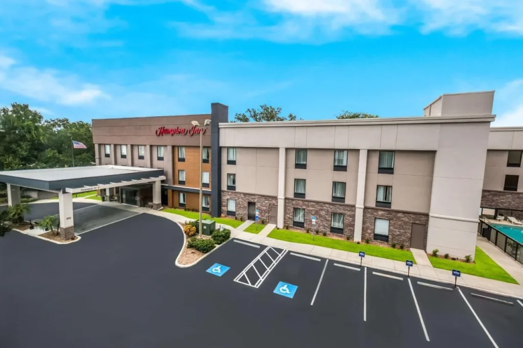 Aerial view of the entrance, parking lot and buildings of Hampton Inn Winter Haven