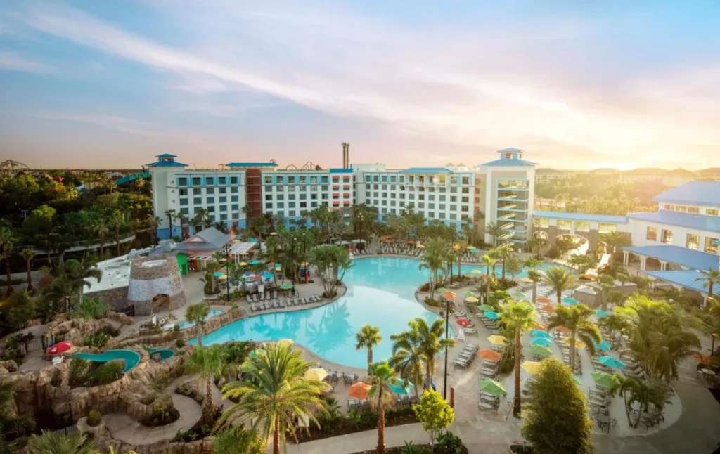 Aerial view of the large pool, waterslide and colorful umbrellas at Loews Sapphire Falls Resort