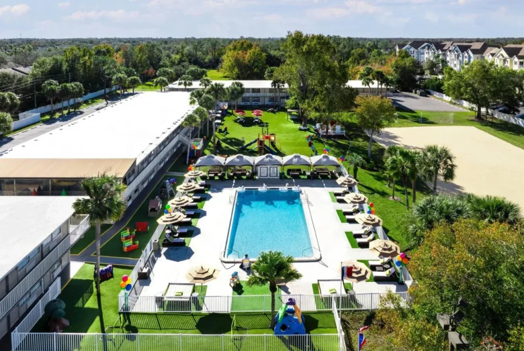 Aerial view of the pool, cabanas and playground at Magic Moment Resort & Kids Club