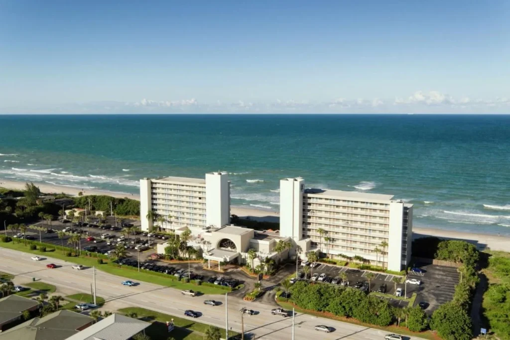 Aerial view of the two DoubleTree Suites Melbourne Beach Oceanfront towers on A1A beside the beach