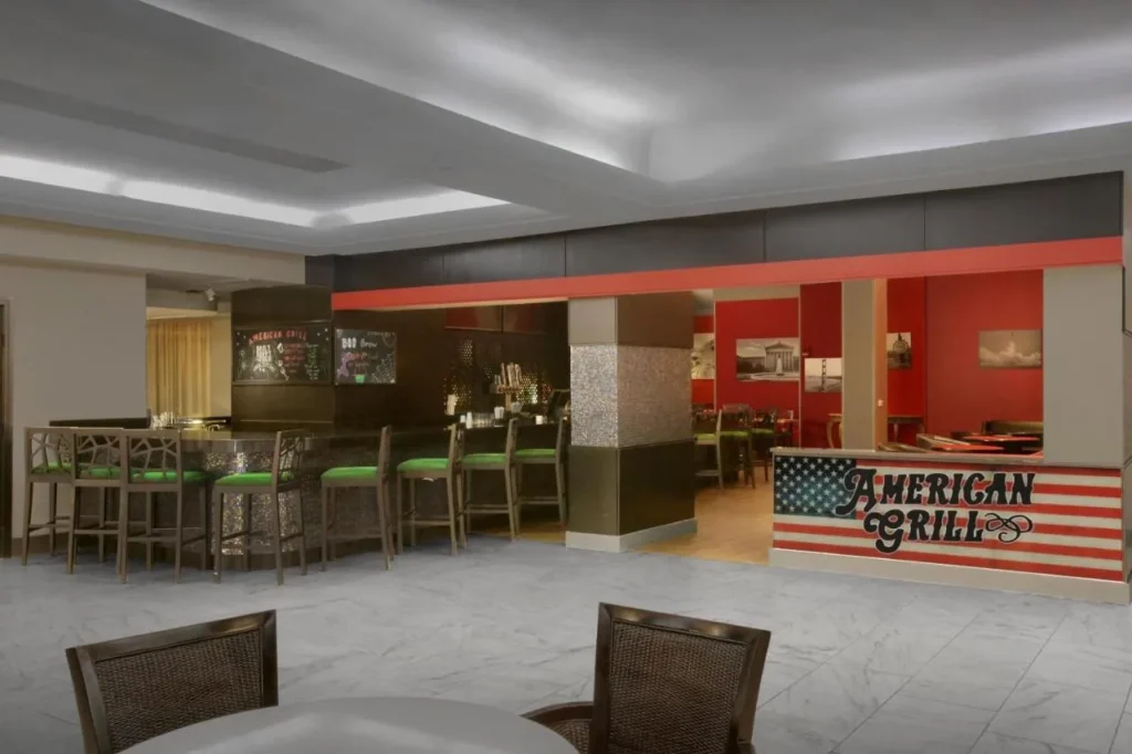 American Grill bar with green stools and dining room at DoubleTree at the Entrance to Universal