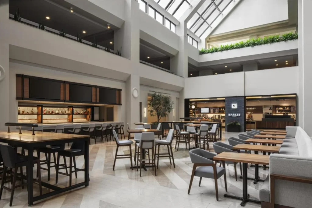 Atrium bar and dining tables beside the Market at Hyatt Regency Orlando