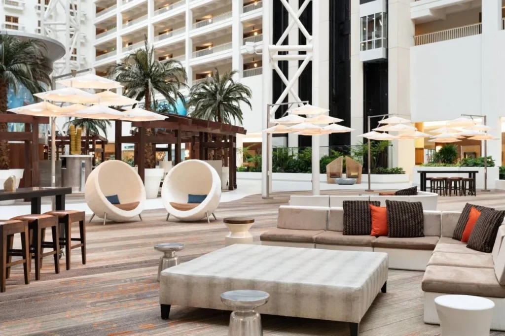 Atrium lounge with sofas, egg chairs and umbrella lights at Renaissance Orlando at SeaWorld