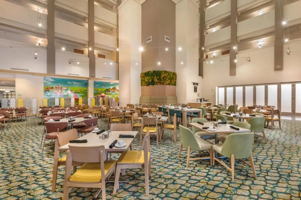 Atrium restaurant with green and yellow chairs at Holiday Inn Orlando &ndash; Disney Springs Area