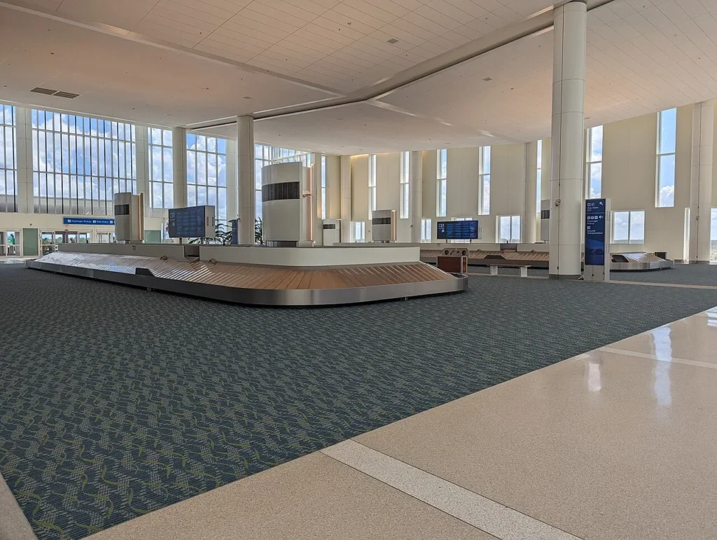 Baggage carousels and tall windows on the Level 6 arrivals hall of Terminal C at Orlando International Airport