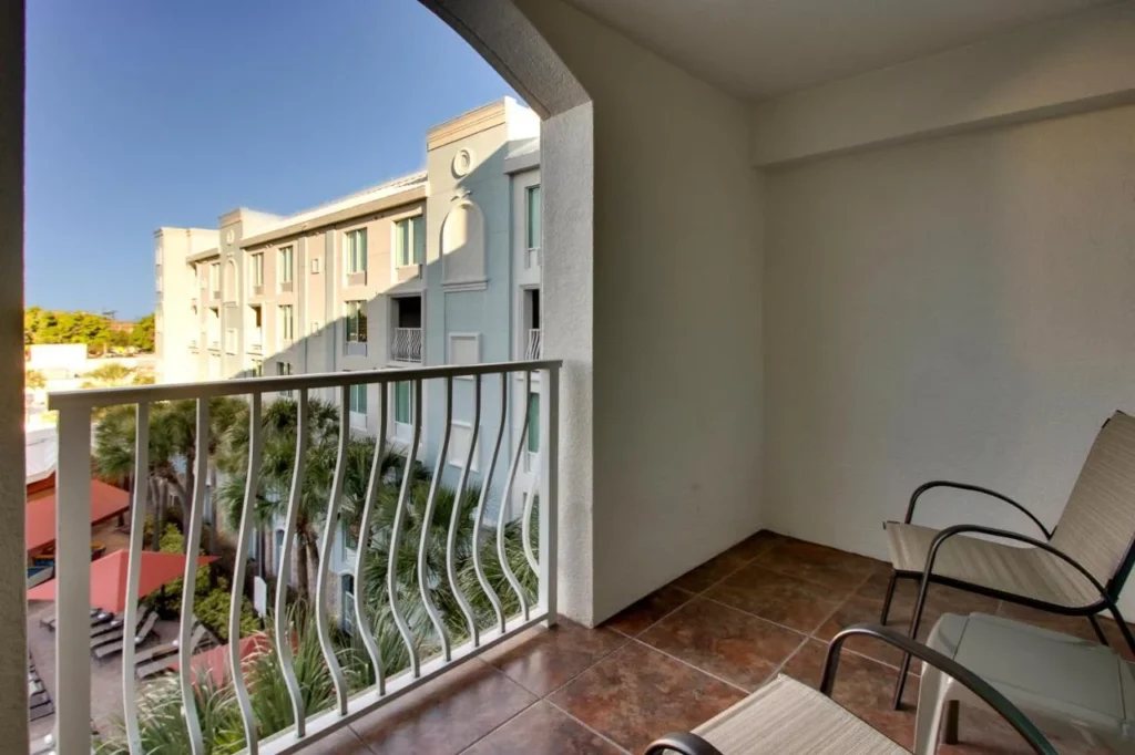 Balcony with two chairs overlooking the courtyard at Holiday Inn Resort Orlando - Lake Buena Vista