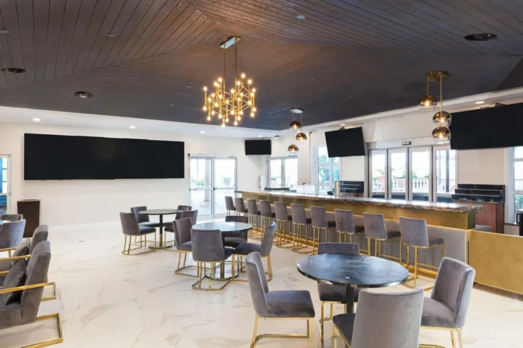 Bar and dining room with marble floor and chandeliers at Westgate Palace near Universal
