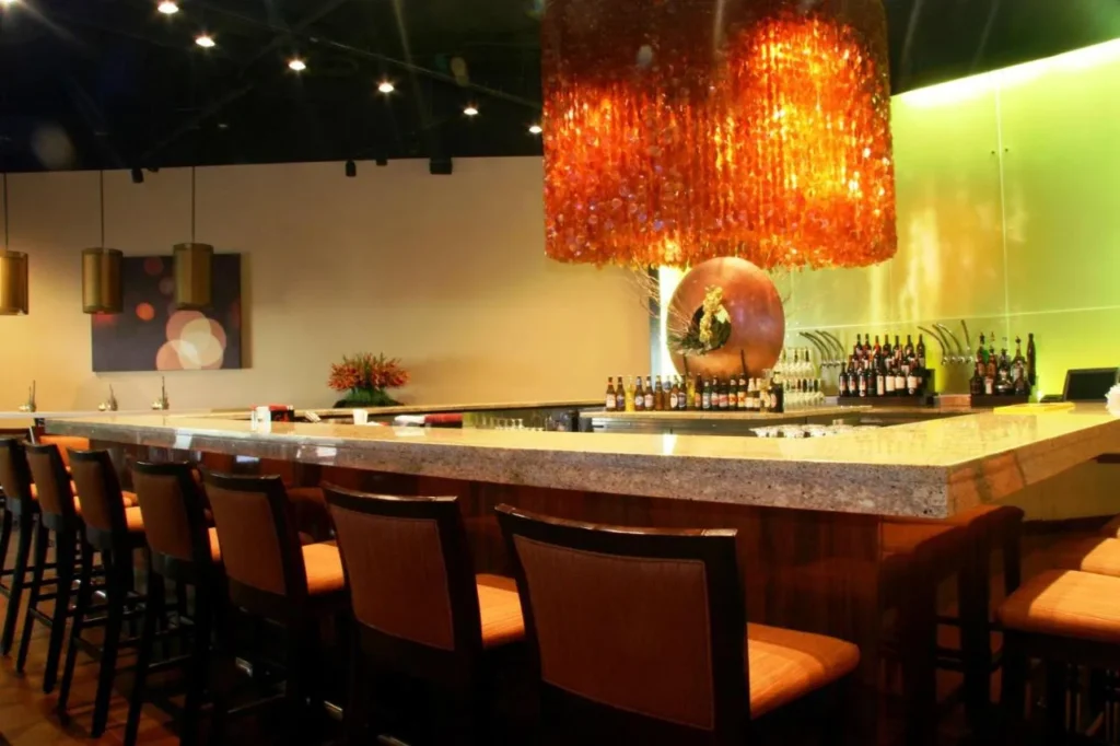 Bar counter with orange pendant chandelier at the DoubleTree by Hilton Orlando Theme Park Resort