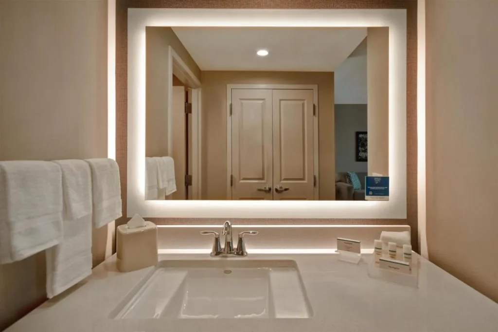 Bathroom vanity with backlit mirror and Neutrogena toiletries at Homewood Suites Flamingo Crossings