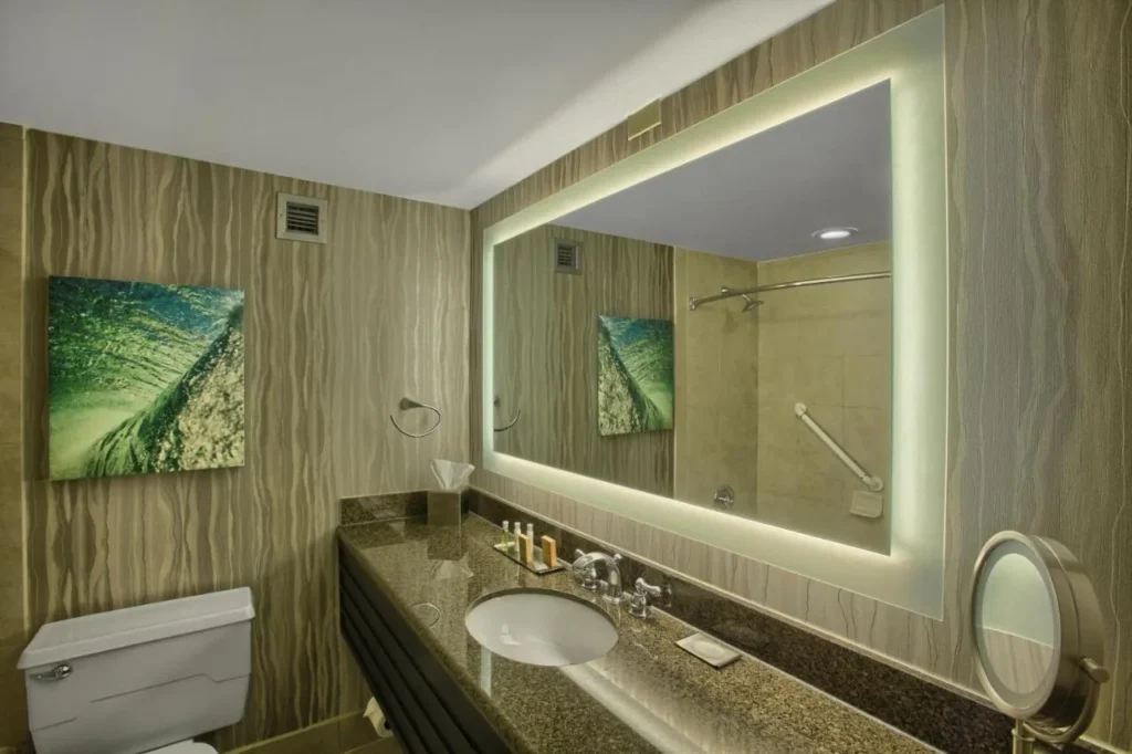 Bathroom vanity with backlit mirror and stone counter, DoubleTree at the Entrance to Universal
