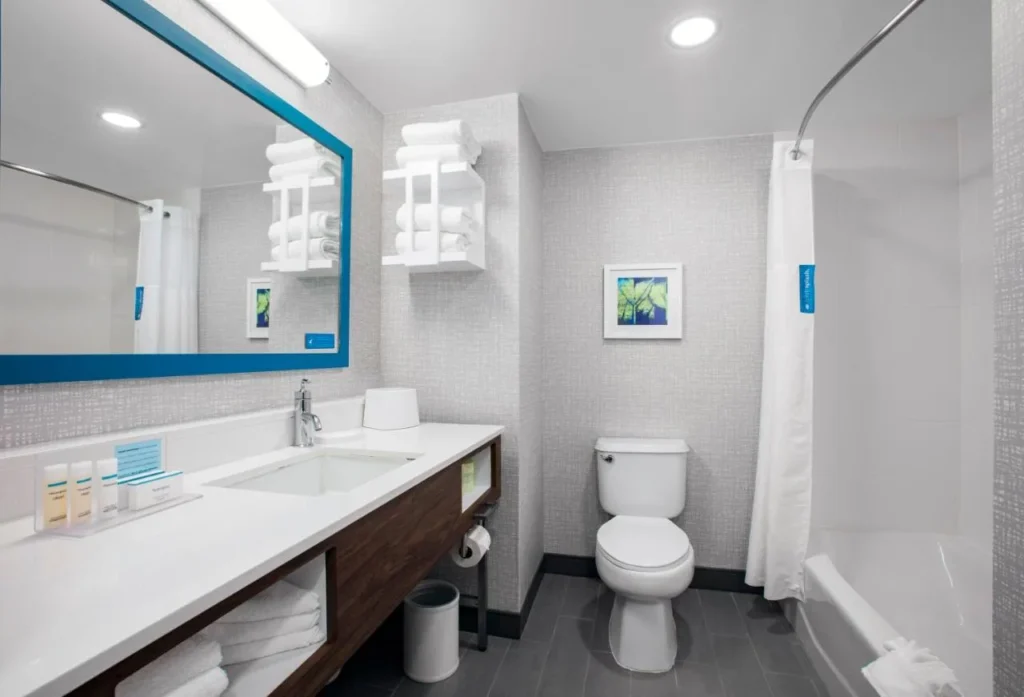 Bathroom with tub, curved shower rod and vanity at Hampton Inn Orlando/Lake Buena Vista