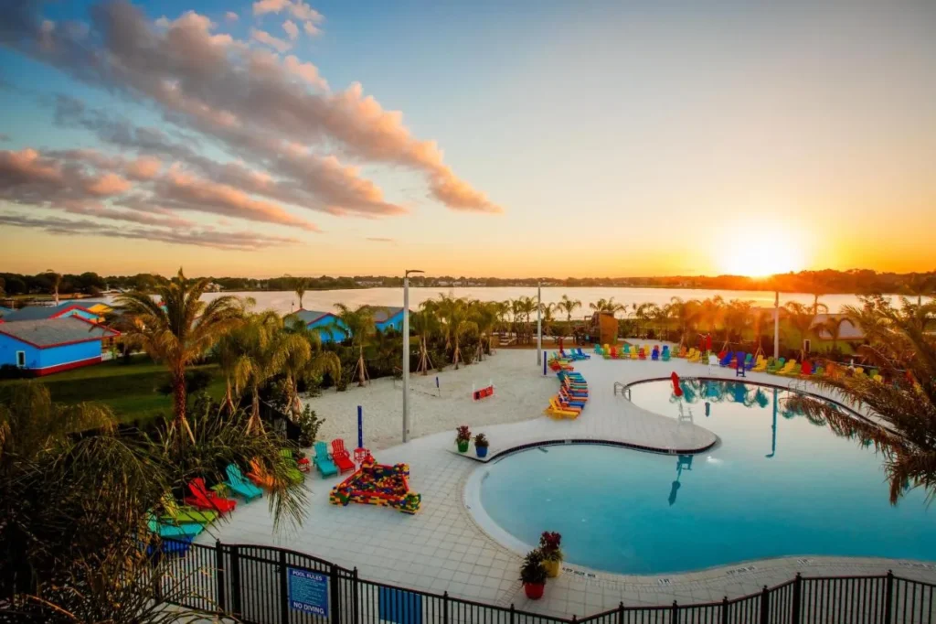 Beach Retreat pool, sandy beach area and Lake Dexter at sunset at LEGOLAND Florida