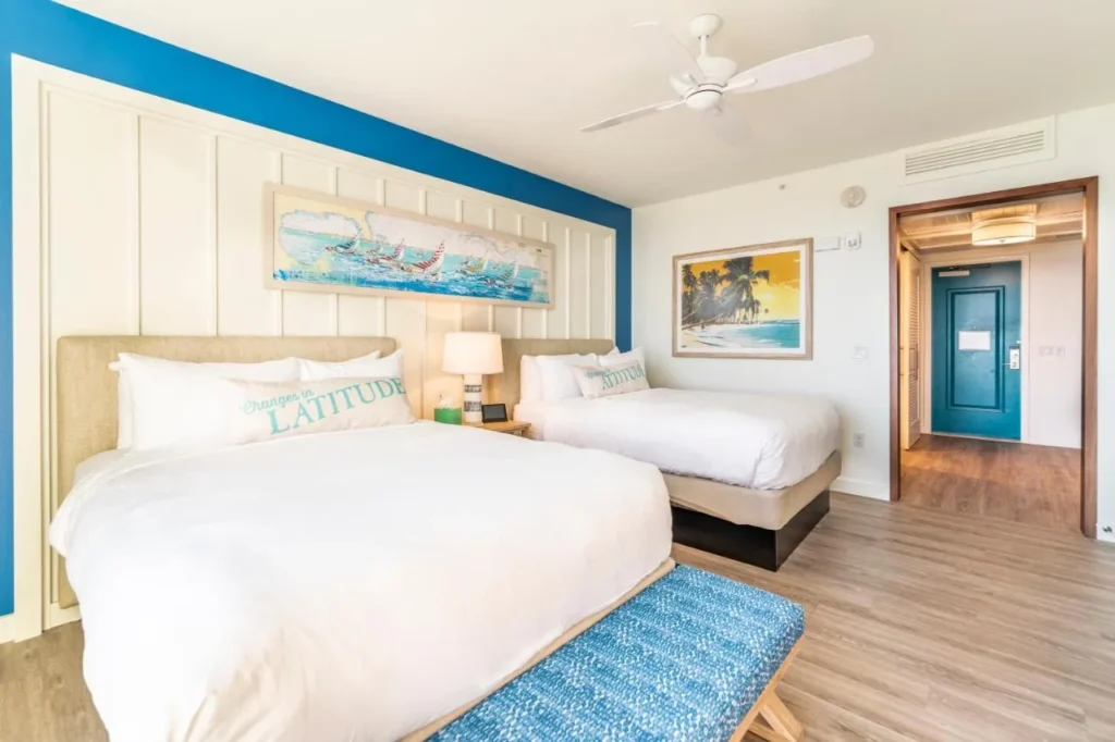 Habitación de playa con dos camas, ventilador de techo y pared de acento azul en Margaritaville Resort Orlando
