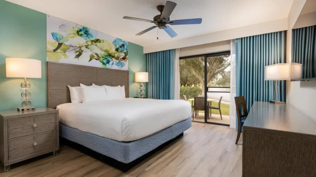 Bedroom with a ceiling fan and sliding glass door to a patio at Orange Lake Resort