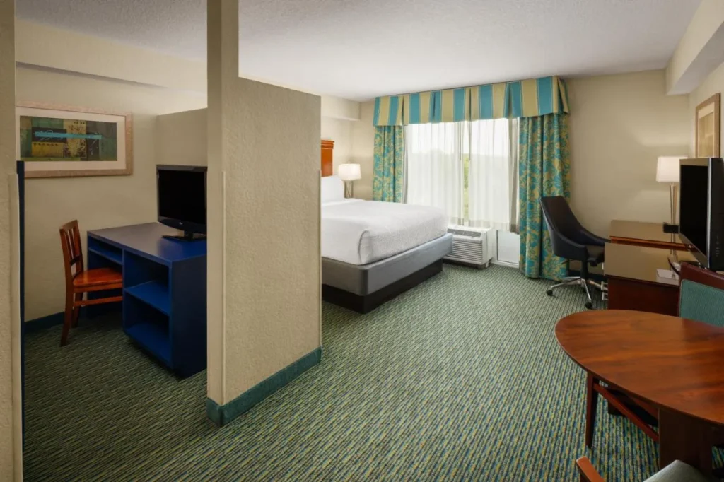 Bedroom with a partitioned desk-and-TV corner at Holiday Inn Resort Lake Buena Vista