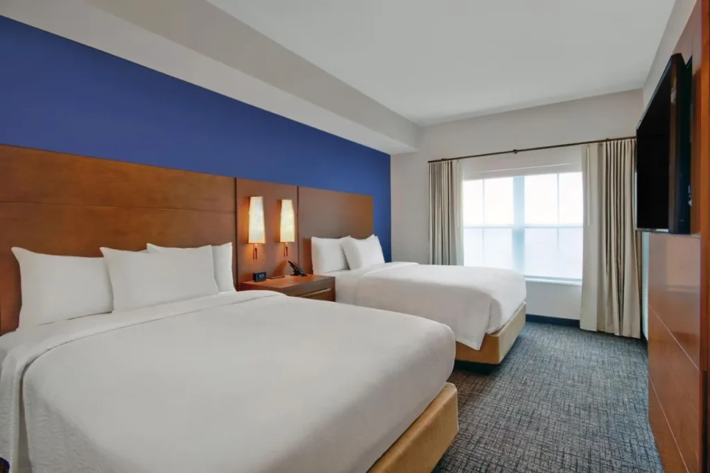 Habitaci&oacute;n con dos camas queen y TV de pared en el Residence Inn Flamingo Crossings