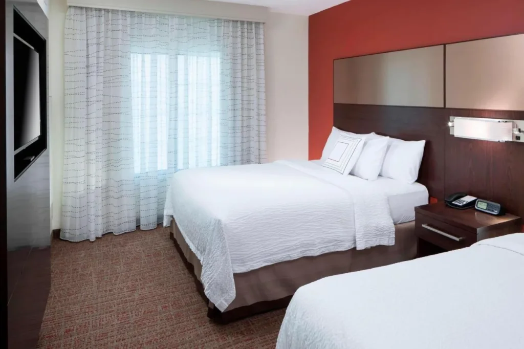 Bedroom with two queen beds and sheer curtains at Residence Inn Near Universal Orlando