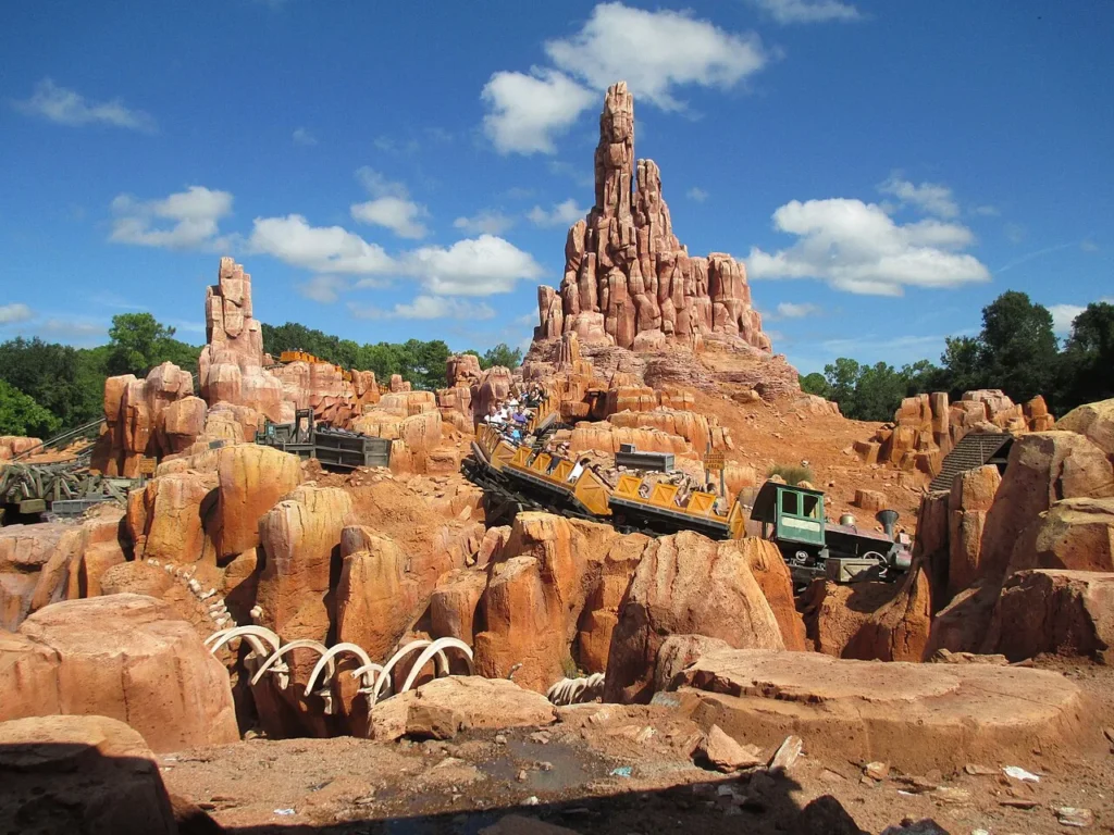 Big Thunder Mountain Railroad train winding through red rock spires at Magic Kingdom