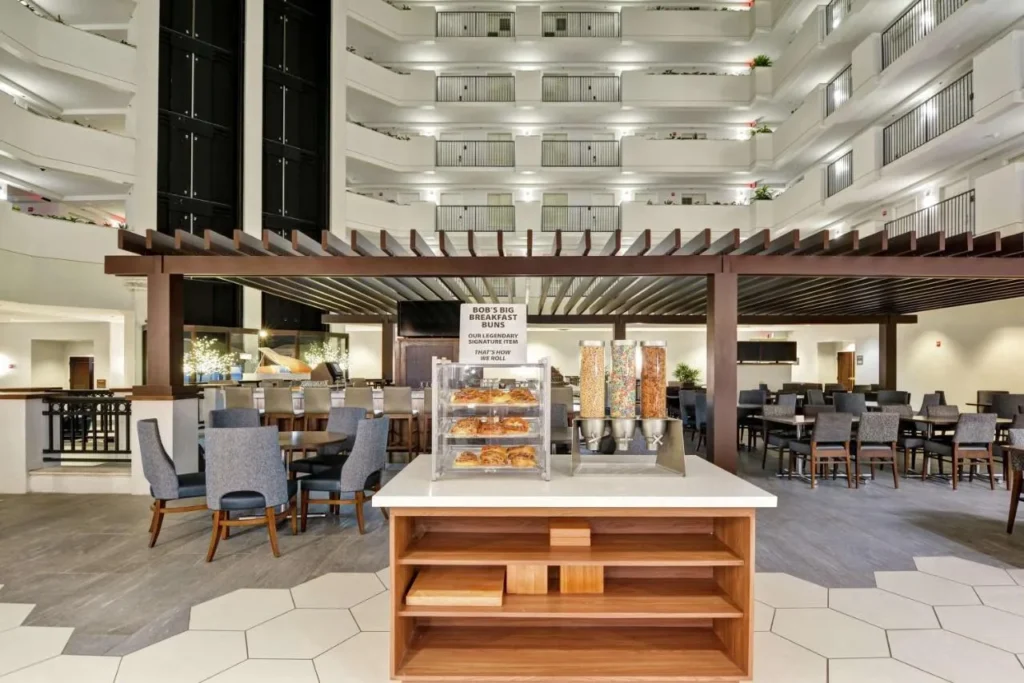 Breakfast area with pastries and cereal dispensers in the atrium at Embassy Suites Orlando Downtown
