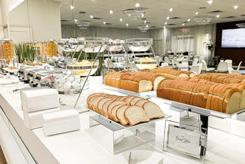 Breakfast buffet bread station with toasters and cereal jars at Magic Moment Resort & Kids Club