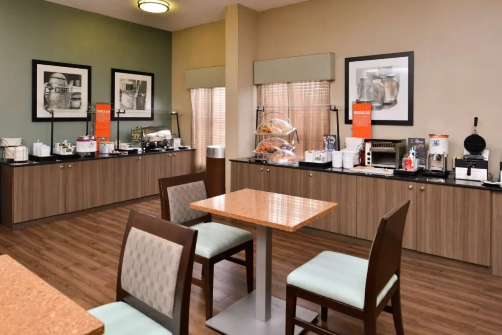 Breakfast buffet counter with waffle maker, toaster and pastries at Hampton Inn Closest to Universal