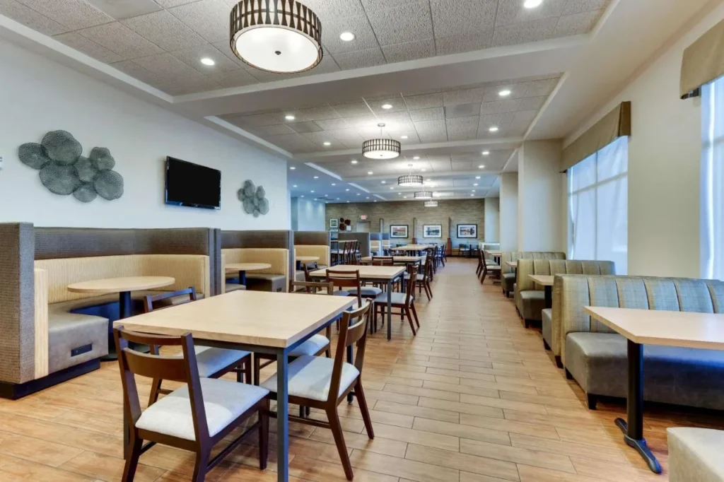Breakfast dining room with booths and tables at Drury Inn & Suites near Universal Orlando Resort
