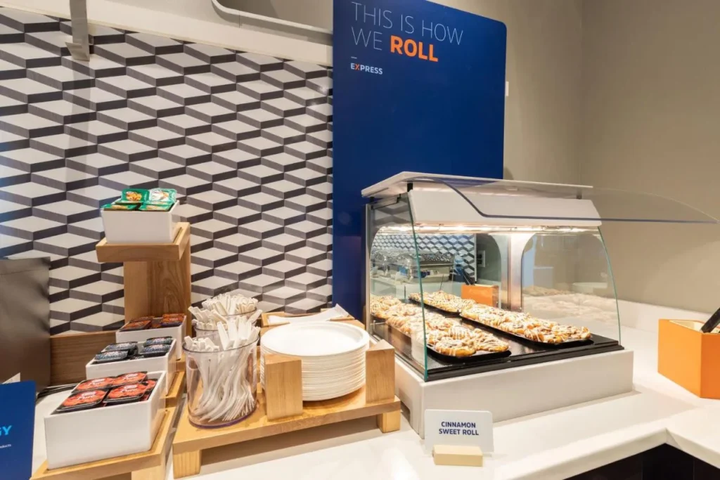 Breakfast pastry counter with cinnamon roll display at Holiday Inn Express Nearest Universal Orlando
