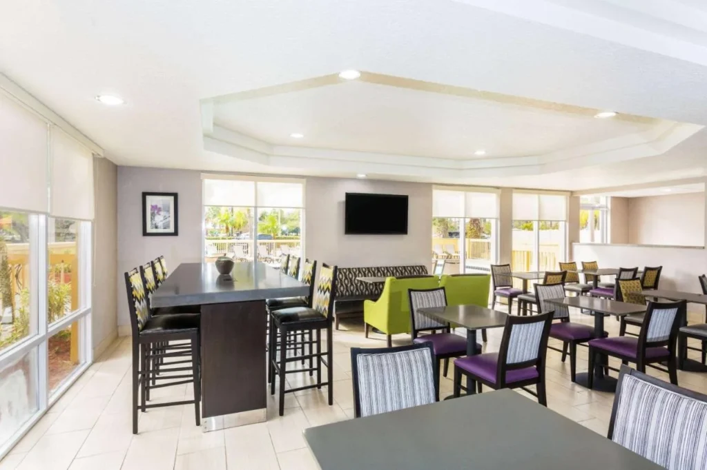 Breakfast room with a high table and purple chairs at La Quinta Orlando Universal area