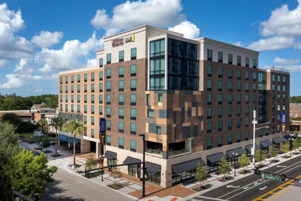 Brick and glass building shared by Hilton Garden Inn and Home2 Suites Orlando Downtown