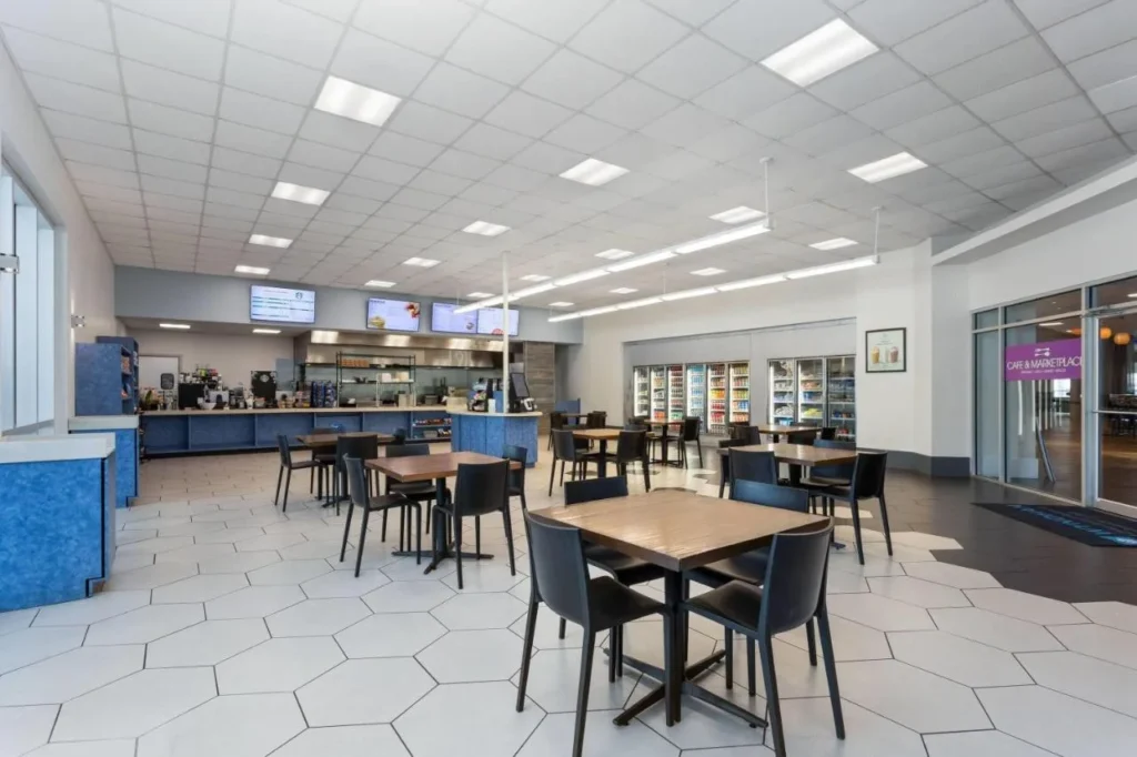 Caf&eacute; and Marketplace dining room with tables, drink coolers and order counter at Wyndham I-Drive Avanti