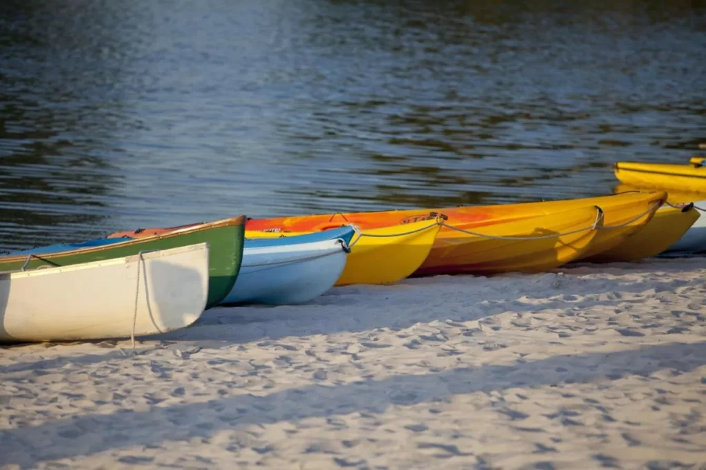 Canoes and kayaks on the sandy beach of Lake Windsong at Hyatt Regency Grand Cypress