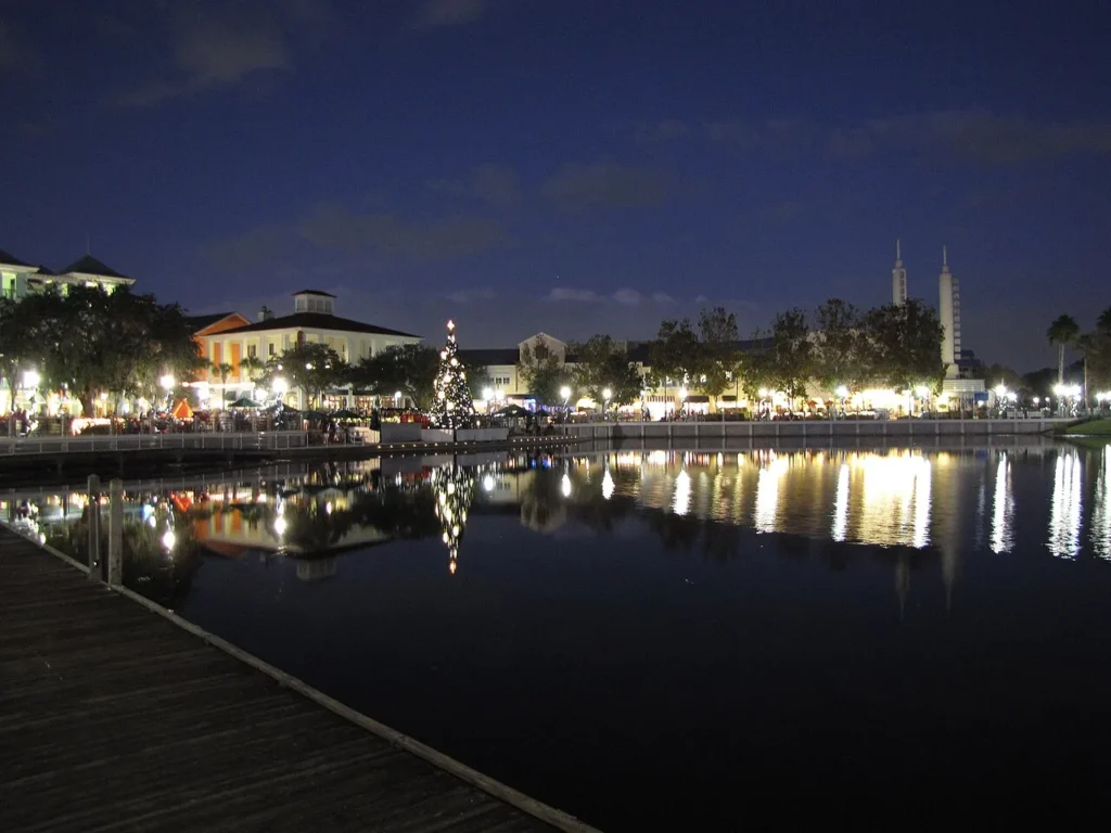 Celebration Town Center lakefront at night with a lit Christmas tree reflected in the lake