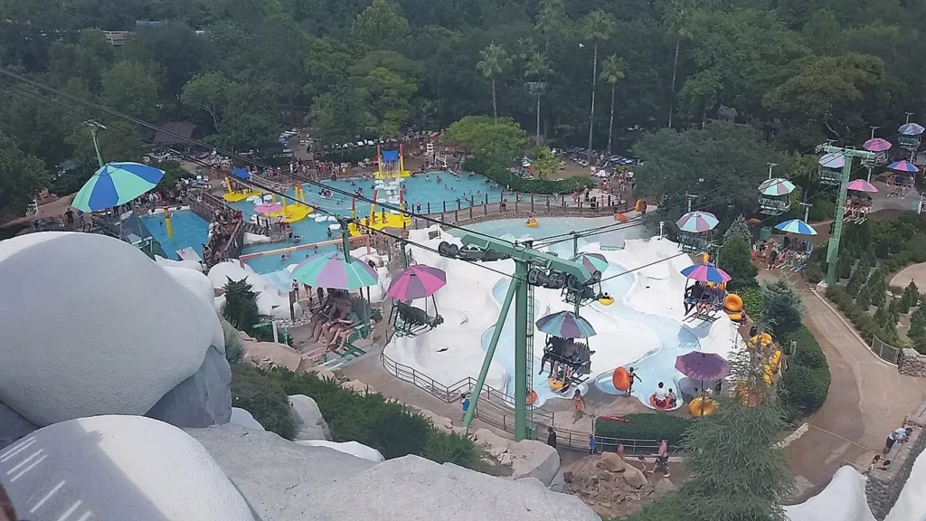Chairlift with striped umbrellas above the pools and tube rides at Disney's Blizzard Beach water park