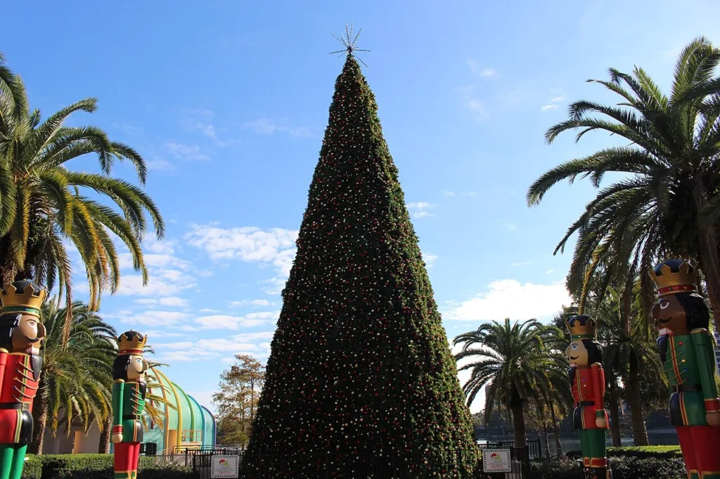 Christmas tree between palm trees and giant nutcracker figures at Lake Eola Park, Orlando