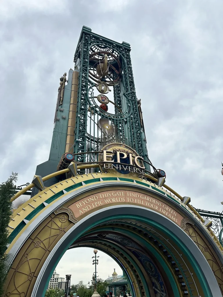 Chronos tower and arched entrance gate of Universal Epic Universe under a cloudy sky