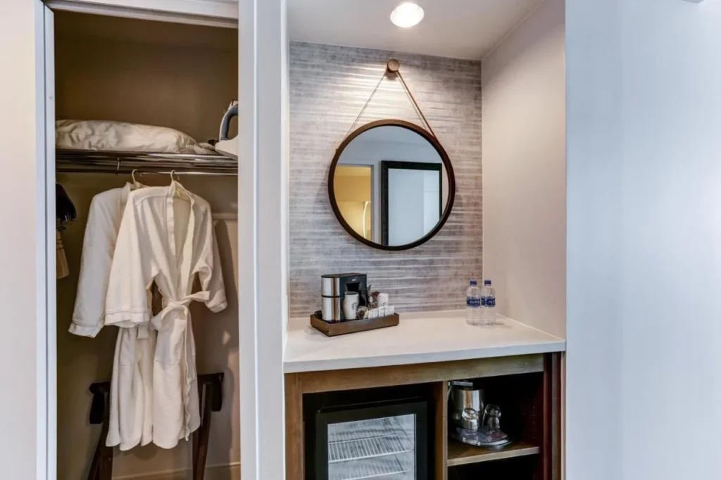Closet with bathrobes beside a coffee maker and minifridge nook at Hyatt Regency Orlando