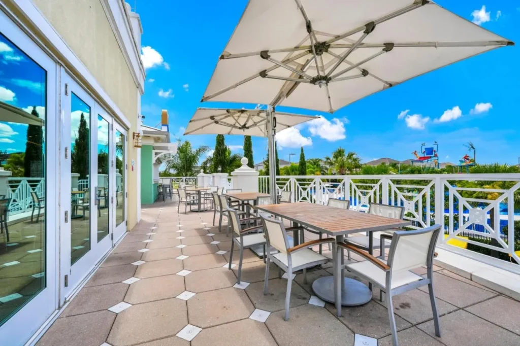 Clubhouse terrace with umbrellas and tables overlooking the water park at Encore Resort
