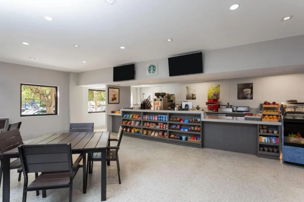 Coffee counter with Starbucks sign, snack shelves and dining tables at Wyndham I-Drive Avanti Resort