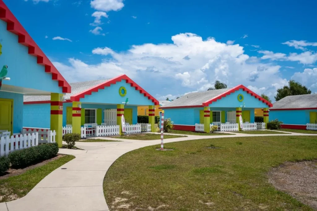 Colorful LEGO-style bungalows with red brick rooflines and lawn at LEGOLAND Beach Retreat