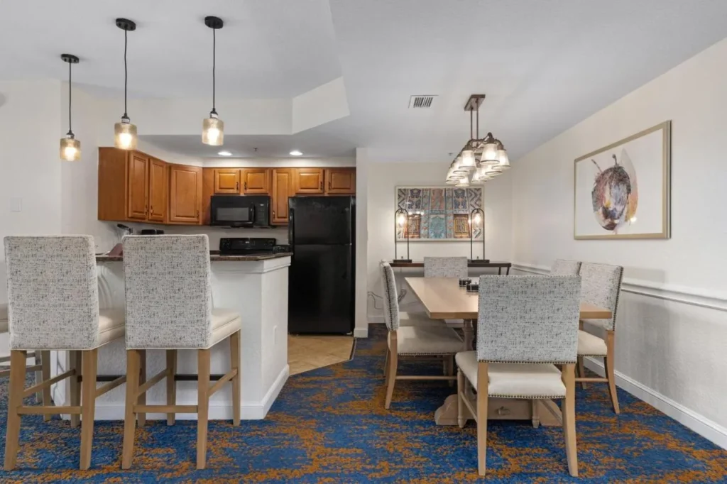 Cocina de condominio con taburetes de barra de desayuno y una mesa de comedor en Club Wyndham Bonnet Creek