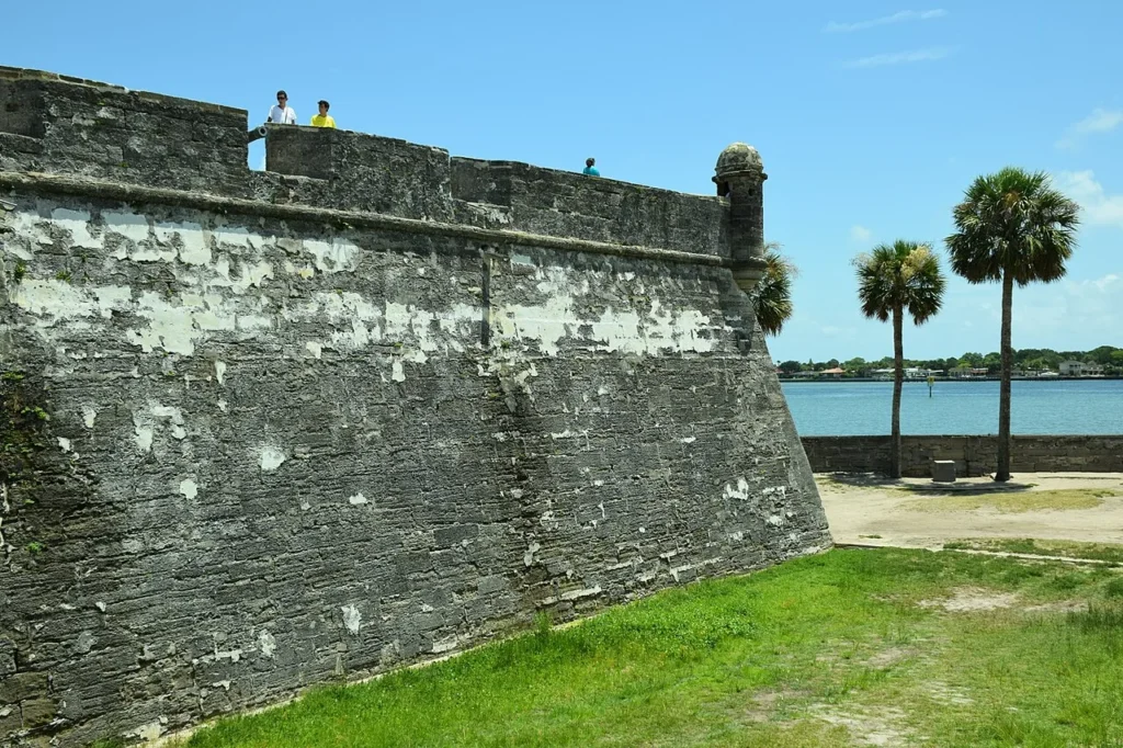 Coquina stone walls and a corner sentry tower of Castillo de San Marcos beside Matanzas Bay