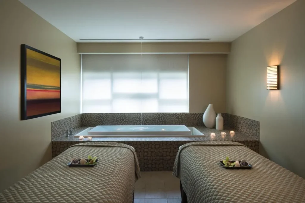 Couples treatment room with two massage tables and a soaking tub at the Hyatt Regency Orlando spa