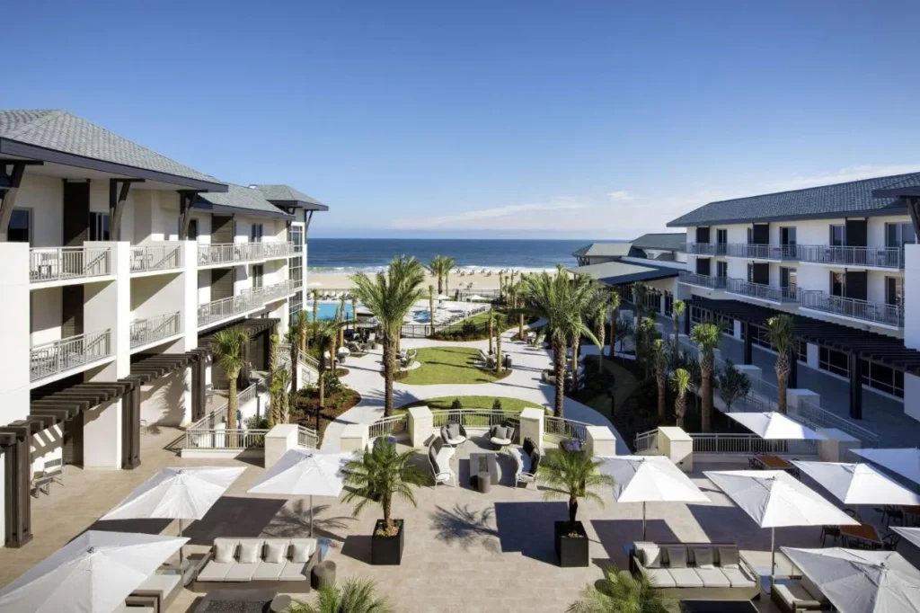 Courtyard, pool area and ocean seen from above at Embassy Suites St. Augustine Beach