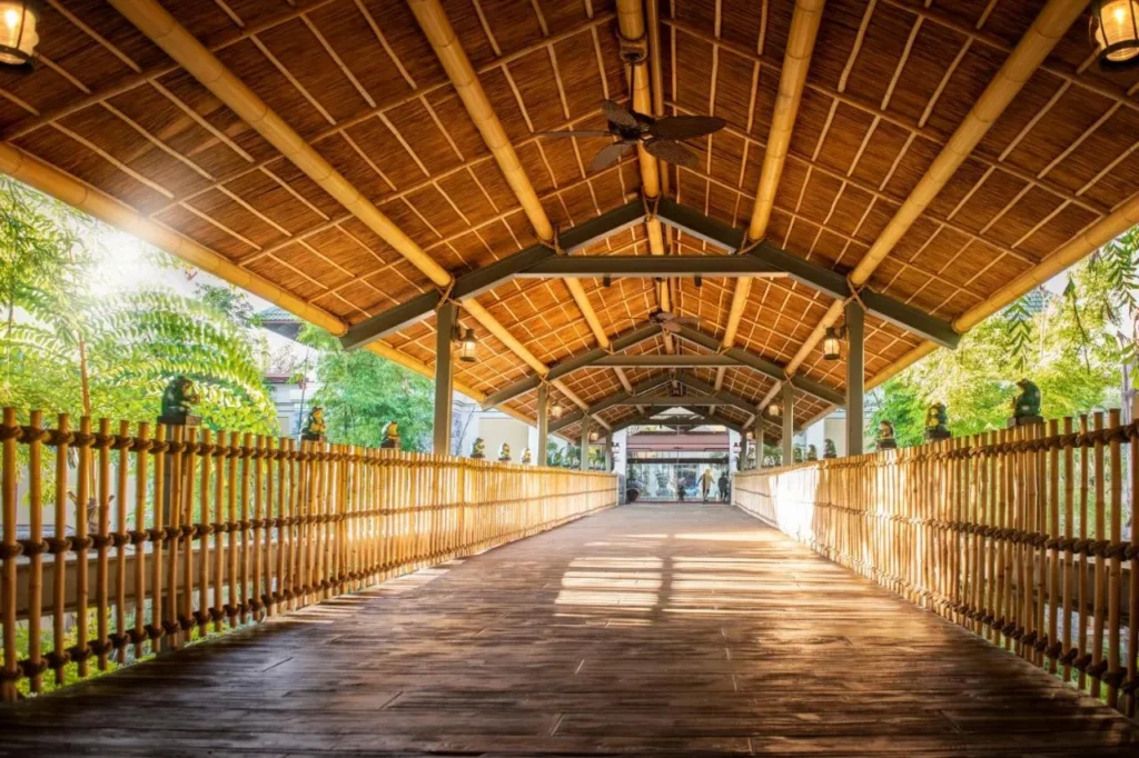 Covered bamboo walkway with ceiling fans leading to the lobby at Loews Royal Pacific Resort