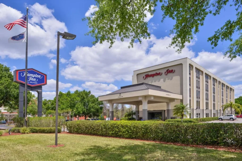 Covered entrance, flagpole and Hampton Inn sign at Hampton Inn Closest to Universal Orlando