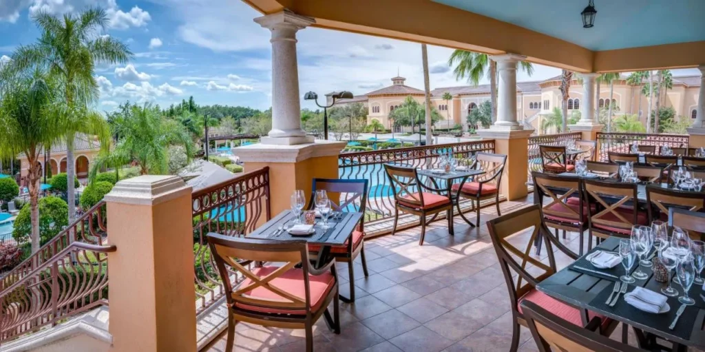 Covered outdoor dining terrace overlooking the pools and grounds at Rosen Shingle Creek